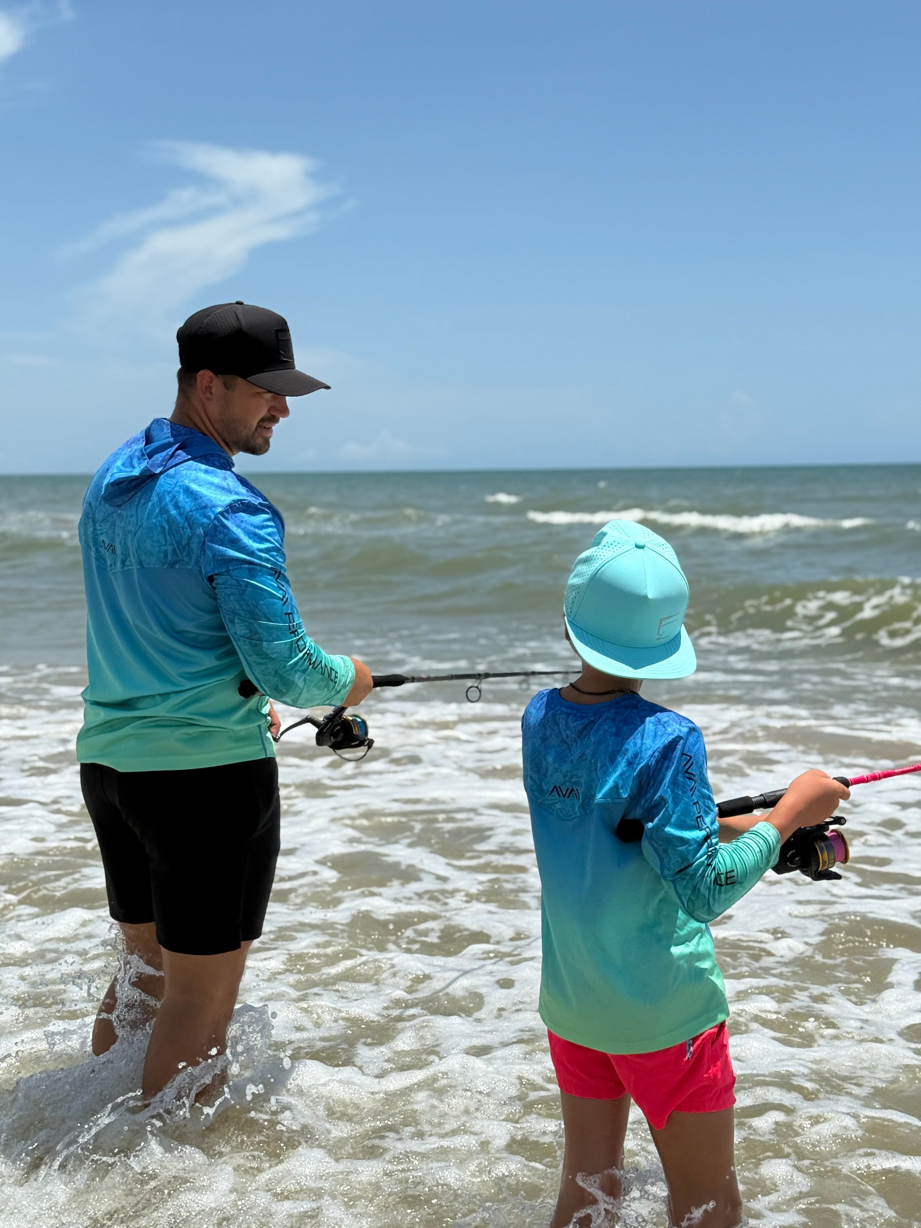 Man and child fishing in the ocean on a sunny day